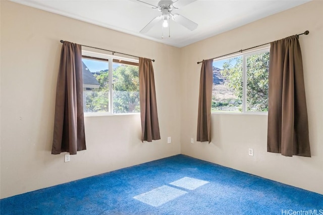 unfurnished room with carpet flooring, ceiling fan, and a healthy amount of sunlight