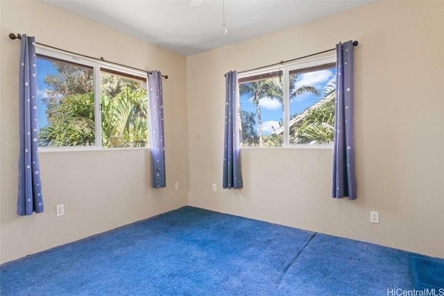 unfurnished room featuring ceiling fan and carpet floors