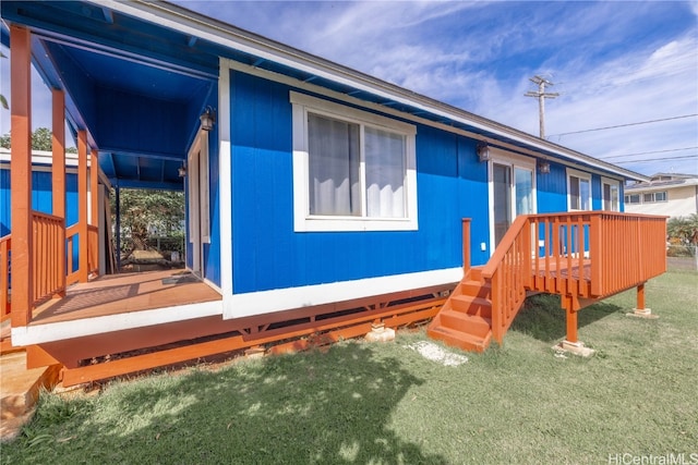 exterior space featuring a deck and a front lawn