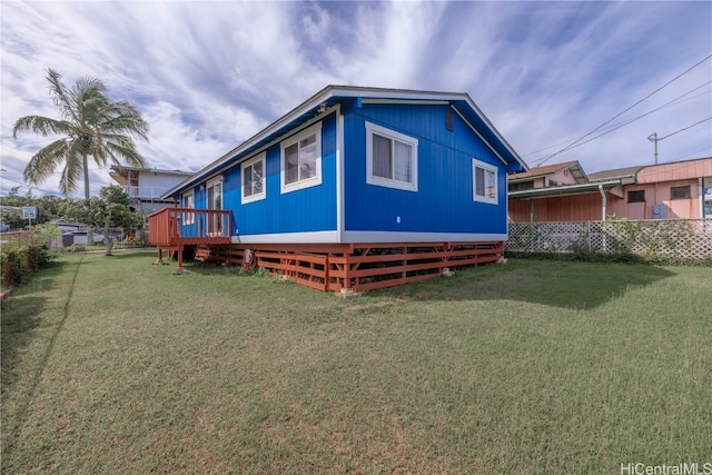 exterior space featuring a lawn and a deck