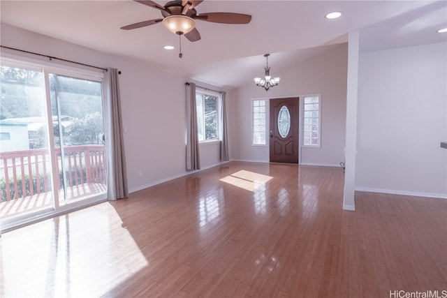 entryway featuring light hardwood / wood-style flooring, ceiling fan with notable chandelier, and vaulted ceiling