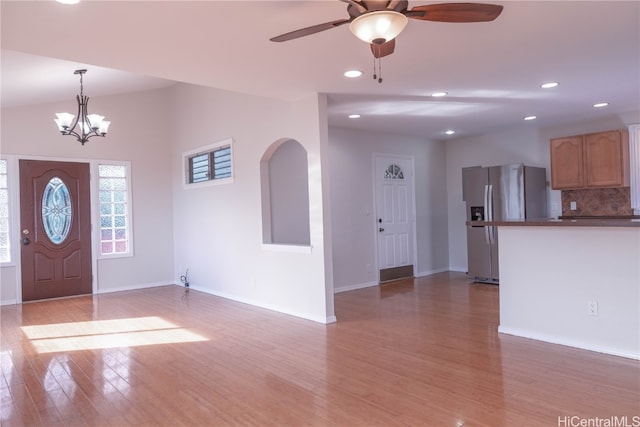 entrance foyer featuring wood-type flooring and ceiling fan with notable chandelier