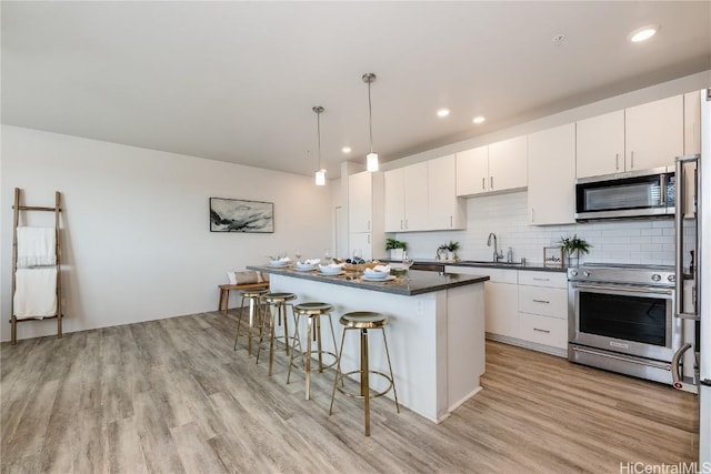 kitchen with a center island, white cabinets, and appliances with stainless steel finishes