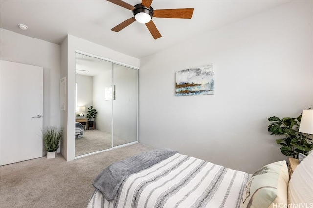 bedroom with carpet flooring, ceiling fan, and a closet