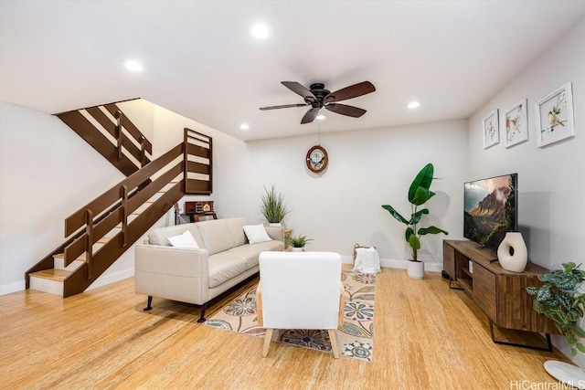 living room with light wood-type flooring and ceiling fan