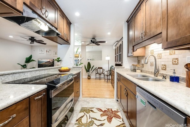 kitchen featuring backsplash, ceiling fan, sink, and stainless steel appliances