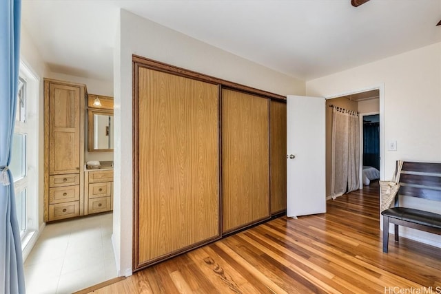 bedroom featuring light wood-type flooring and a closet