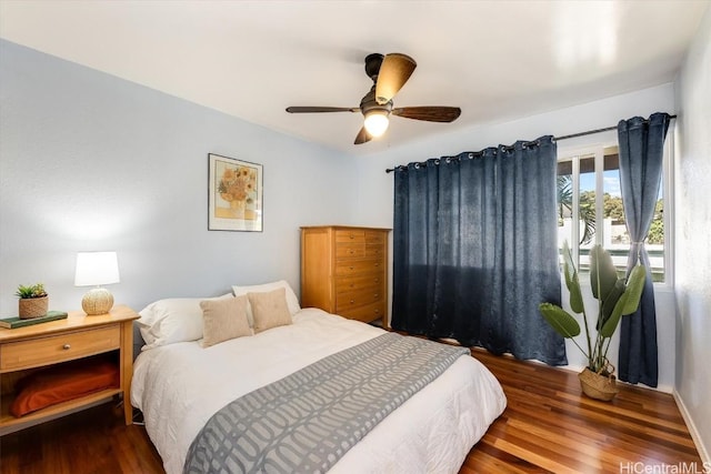 bedroom with ceiling fan and dark wood-type flooring