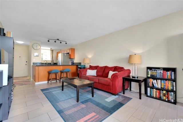 living room with sink and rail lighting