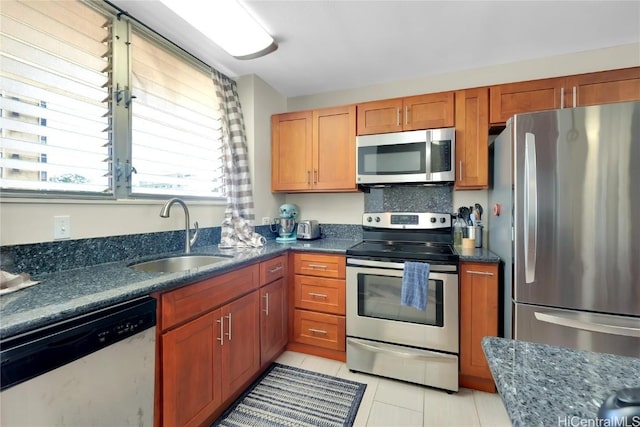 kitchen with light tile patterned flooring, stainless steel appliances, and sink