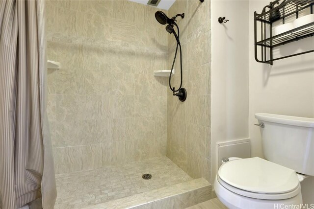 bathroom with a shower with curtain and toilet