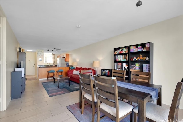 dining space featuring rail lighting