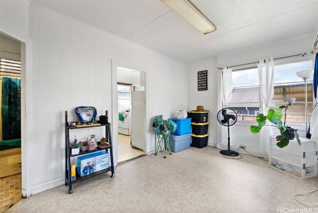 misc room featuring wood walls and separate washer and dryer