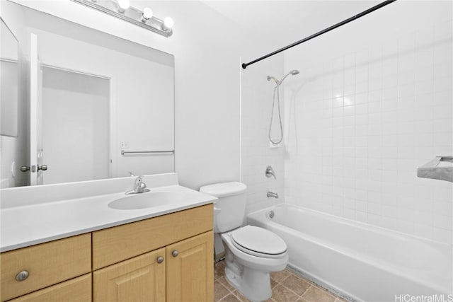 full bathroom featuring tiled shower / bath, tile patterned floors, vanity, and toilet