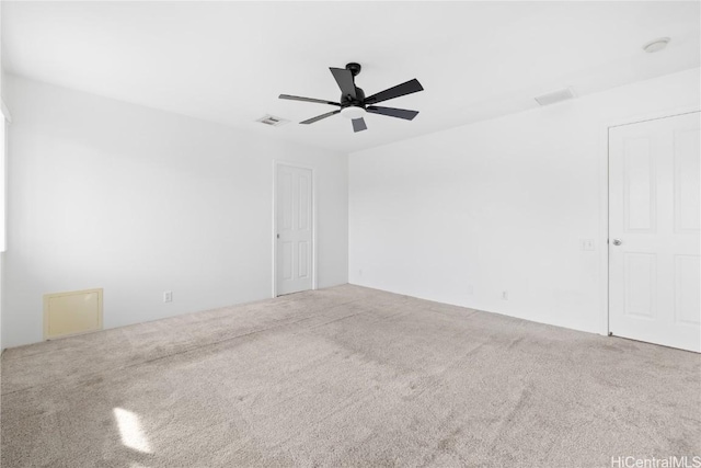 carpeted spare room featuring ceiling fan