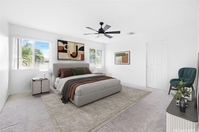 bedroom with light colored carpet and ceiling fan