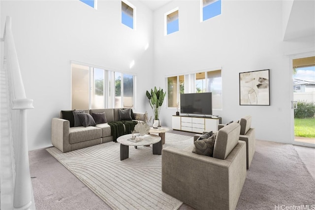 carpeted living room featuring a high ceiling