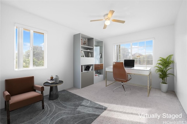 carpeted office space featuring ceiling fan and a wealth of natural light