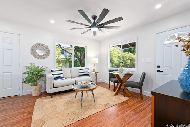 living room with ceiling fan, hardwood / wood-style floors, and a healthy amount of sunlight