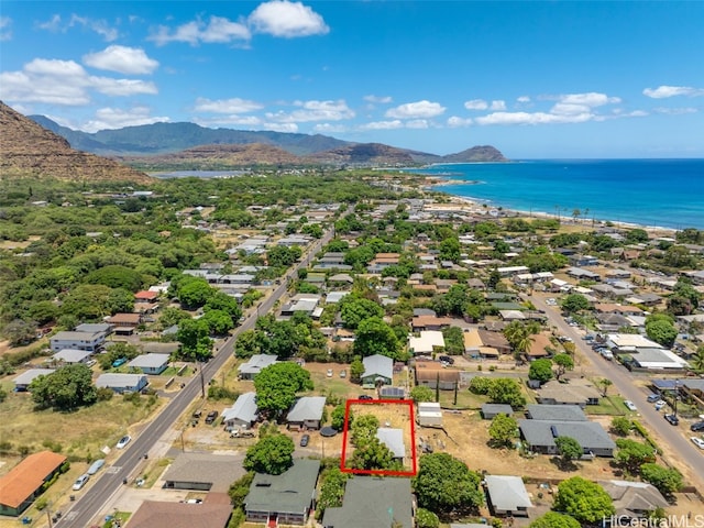 birds eye view of property with a water and mountain view