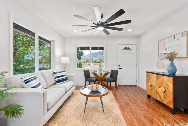 living room featuring ceiling fan and light wood-type flooring