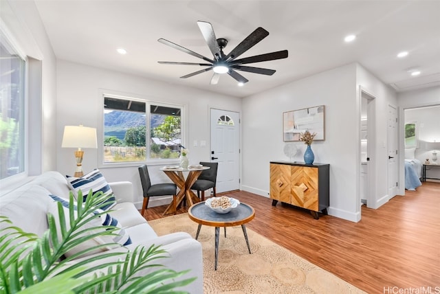 living room featuring ceiling fan and light hardwood / wood-style flooring