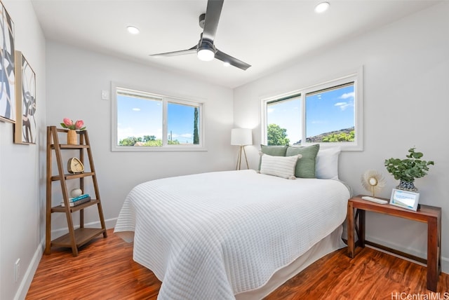 bedroom with ceiling fan and dark hardwood / wood-style floors