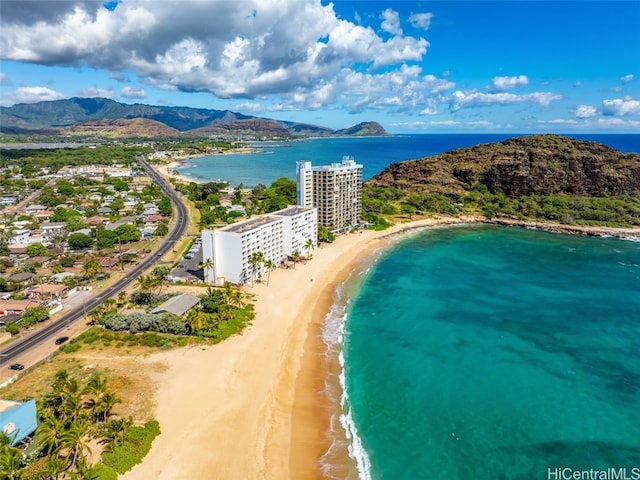 aerial view with a water and mountain view and a beach view