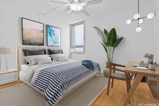 bedroom with hardwood / wood-style flooring and ceiling fan