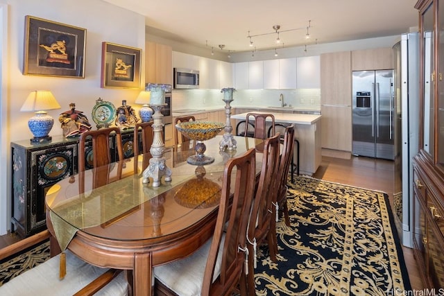 dining area featuring hardwood / wood-style floors and sink