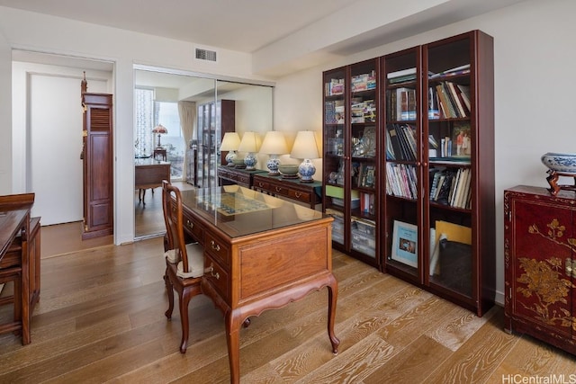 office with light wood-type flooring