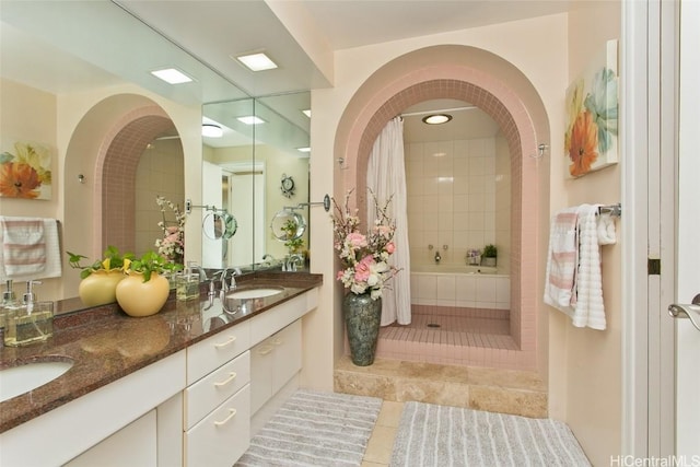 bathroom with tile patterned floors, shower / bath combination with curtain, and vanity