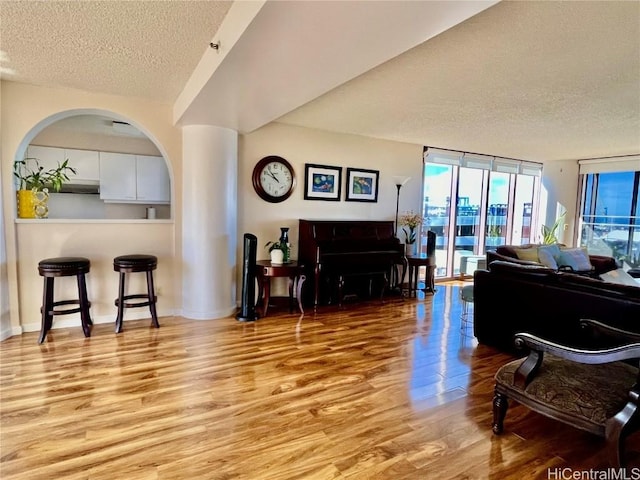 miscellaneous room with light hardwood / wood-style floors and a textured ceiling