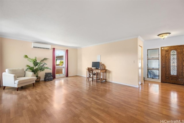 entrance foyer featuring a wall unit AC, light hardwood / wood-style floors, and ornamental molding