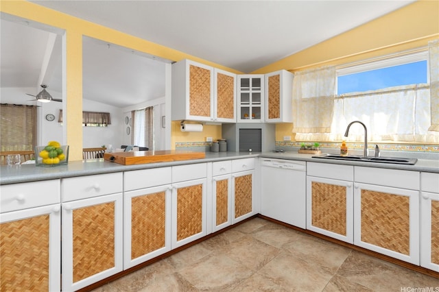 kitchen featuring a sink, vaulted ceiling, white cabinetry, glass insert cabinets, and white dishwasher