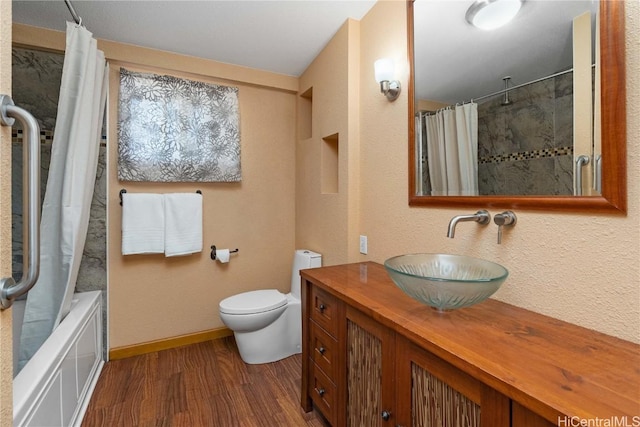 full bathroom featuring wood-type flooring, toilet, vanity, and shower / bath combo with shower curtain