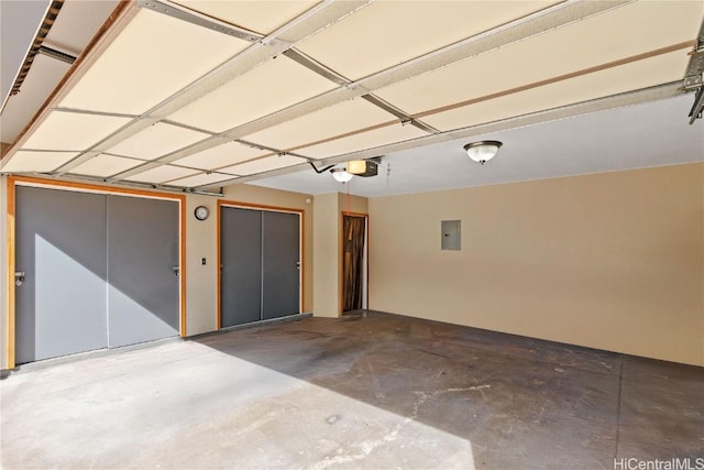 garage with a garage door opener and electric panel