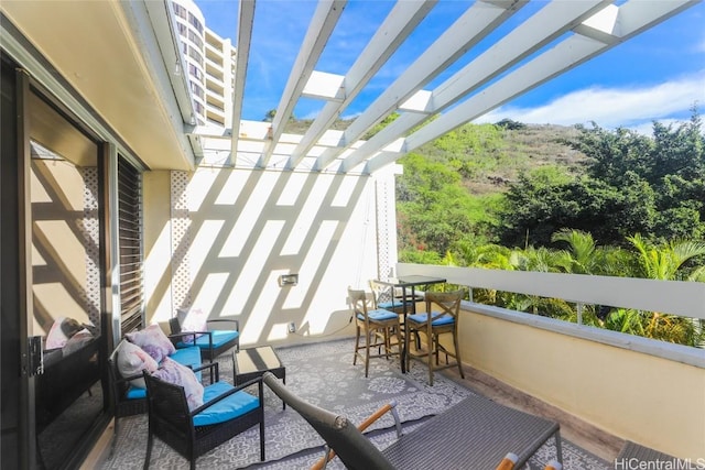 balcony featuring a pergola and outdoor lounge area