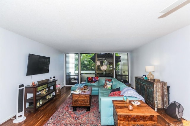 living room with a textured ceiling, ceiling fan, expansive windows, and dark hardwood / wood-style floors