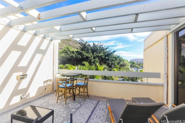 balcony featuring a pergola and a mountain view