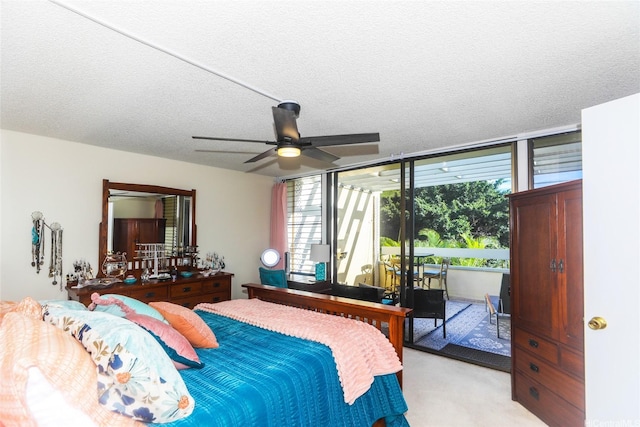 6770 Hawaii Kai Dr Unit 24, Honolulu, HI 96825 - bedroom featuring access to outside, multiple windows, light colored carpet, a ceiling fan, and a textured ceiling