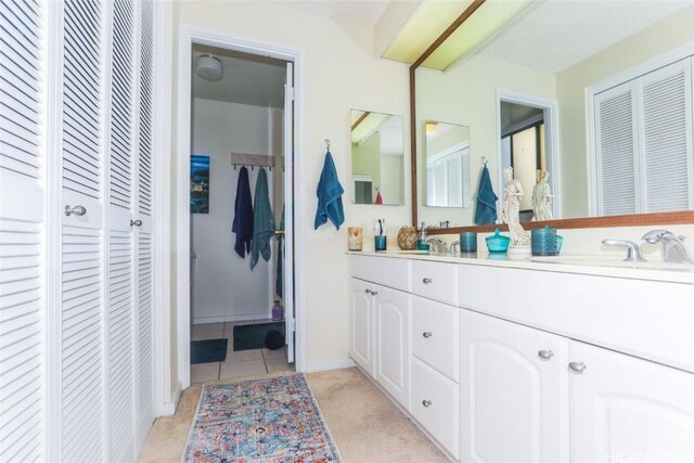 bathroom with tile patterned floors and vanity