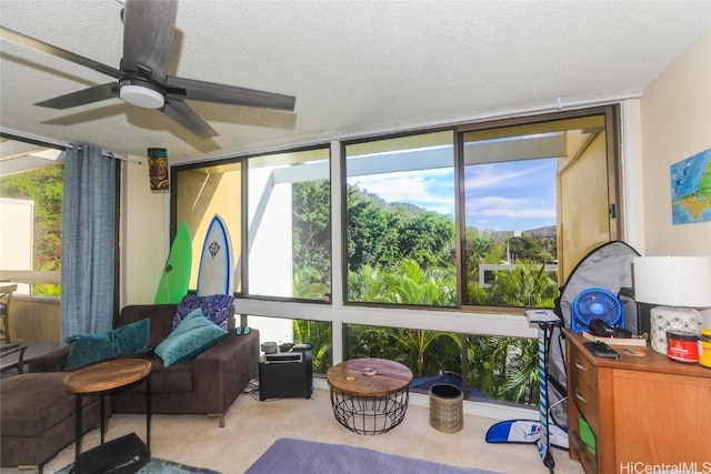 sunroom featuring ceiling fan