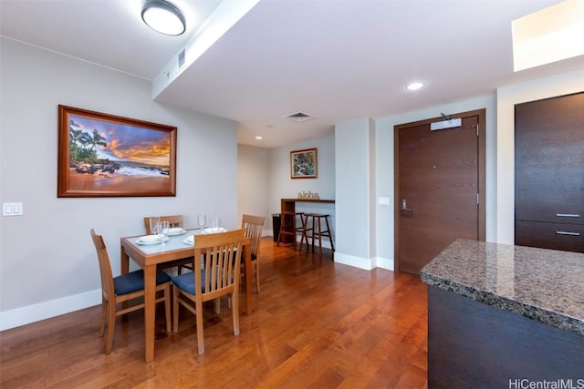 dining area with dark hardwood / wood-style floors