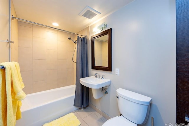 bathroom featuring tile patterned flooring, toilet, and shower / bath combo with shower curtain