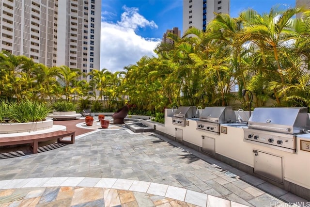 view of patio / terrace featuring exterior kitchen and a grill