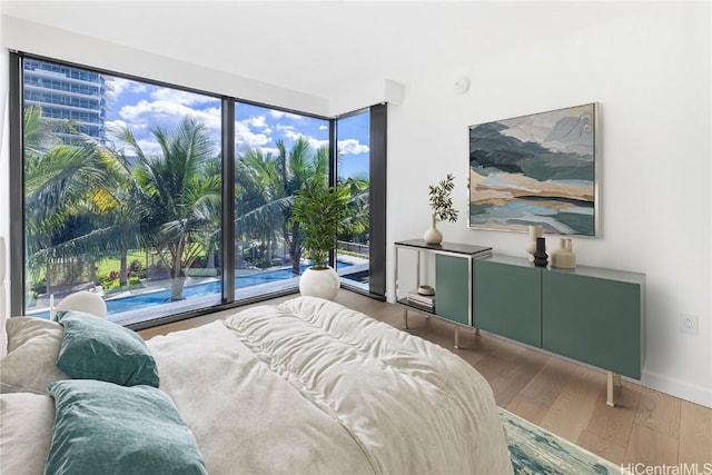 bedroom featuring hardwood / wood-style flooring and multiple windows