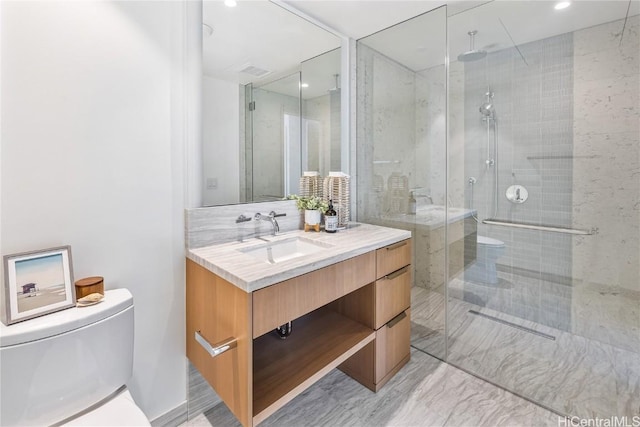 bathroom with vanity, toilet, and a shower with door