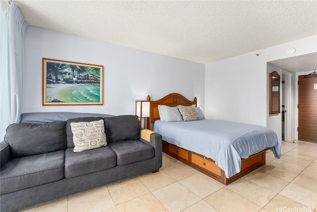 bedroom with a textured ceiling and light tile patterned flooring