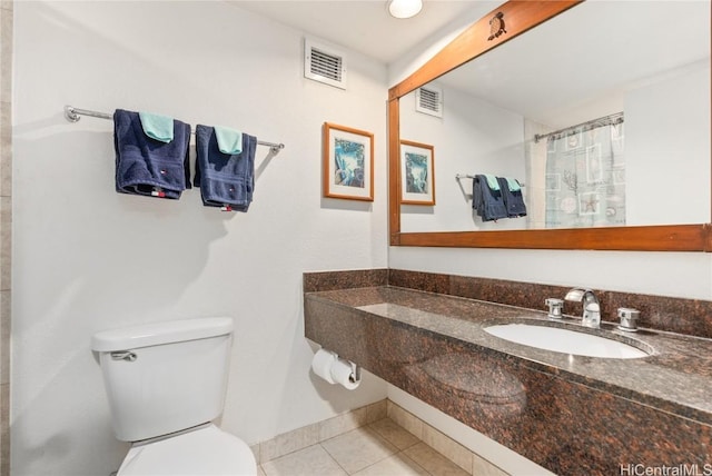 bathroom featuring tile patterned floors, toilet, a shower with curtain, and sink